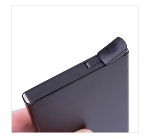 Macro view of black matte RFID blocking card holder with automatic pop-up mechanism