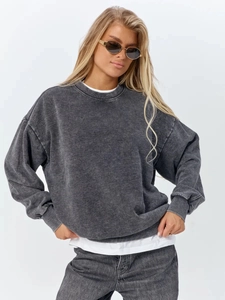 Macro detail of acid-washed grey sweatshirt texture and distressed vintage cotton fabric