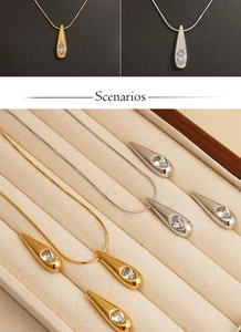 Detailed view of gold and silver teardrop necklaces with sparkling crystal pendants