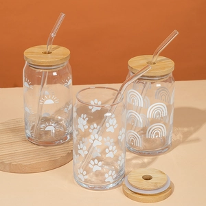 Three large glass can cups with bamboo lids, glass straws and minimalist white prints