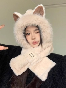 Detail showing plush cream fox ear hooded scarf with brown inner lining and woven logo