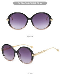 Detail of round sunglasses featuring gradient frames and golden leaf textured temples