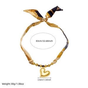 Gold-plated heart pendant on a colorful ribbon chain with vintage bird and floral prints