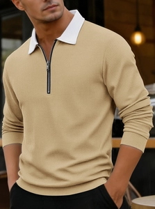 Close-up of khaki waffle knit texture with white contrast collar and metal zipper detail