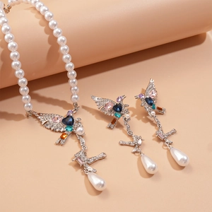 Elegant pearl jewelry set with colorful gemstone bird necklace and matching drop earrings