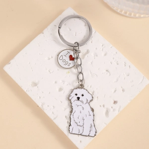 Detailed close-up of a white Maltese dog metal keychain with 'I ❤️ Dogs' enamel tag