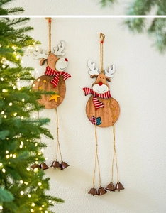 Detail view of two wooden reindeer ornaments with bells hanging on a festive Christmas tree