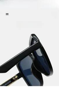Detail of square sunglasses showing golden metal hinges and blue gradient lenses