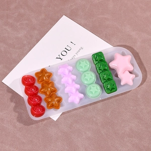 Detailed view of a silicone mold with star-shaped resin crafts and pearlescent finishes
