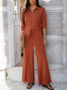 Detailed view of women casual brick red long sleeve shirt and wide leg trousers set