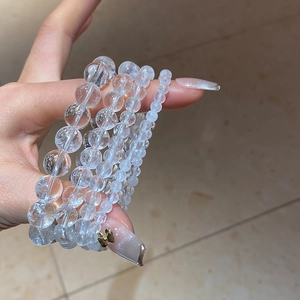 Detailed view of layered clear white crystal beaded bracelet with various bead sizes