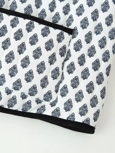 Detail view of cotton jacket with blue leaf print and quilted texture design