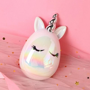 Close-up of holographic unicorn detangling brush with silver horn and glitter details
