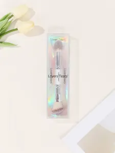 Detail of dual-ended makeup brush with soft bristles in holographic laser packaging