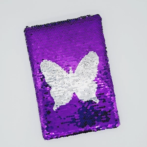 Taccuino viola con paillettes reversibili e un motivo creativo a farfalla bianca