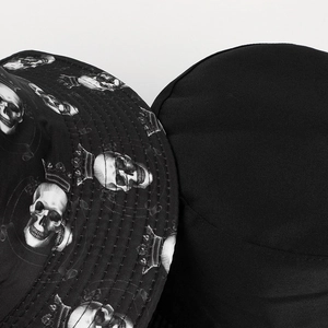 Detail of reversible bucket hat showing skull print pattern and solid black fabric sides