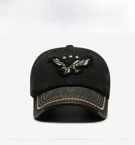 Detail der grauen Vintage-Basecap mit Adler-Stickerei und Lederverzierung am Schirm