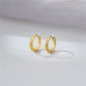 Minimalist gold hoop earrings with textured hammered finish in vintage chic style