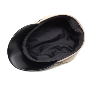 Beige wool baker boy hat with black faux leather brim and metallic side button detail