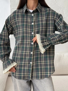 Detail of vintage plaid shirt featuring unique lace-trimmed cuffs and retro check pattern
