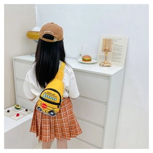 Rear view of child wearing yellow school bus chest bag with realistic stop sign detail