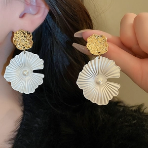 Elegant gold flower drop earrings with white textured petals and pearl center detail