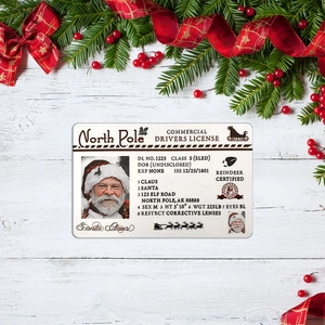 Macro view of Santa Claus Sled Driver License on festive white wooden background