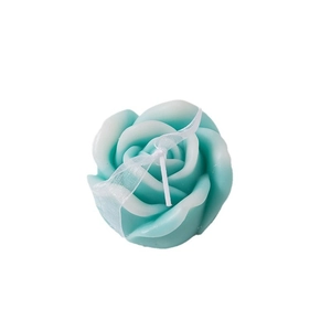 Blue and white gradient rose candle with lace ribbon on a minimalist white background