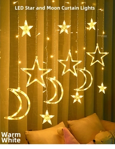 Detail of warm white LED star and moon curtain lights on beige textured curtains