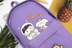 Close-up of purple canvas pencil case featuring cute cartoon prints and sturdy zipper detail