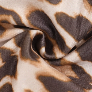 Macro shot of leopard print fabric detail showing fine knit texture and ruffles