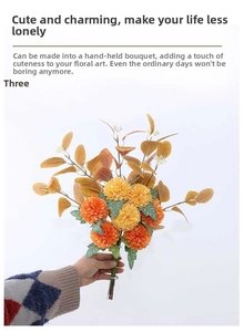 Detail of orange and yellow artificial ping pong mum bouquet with eucalyptus leaves
