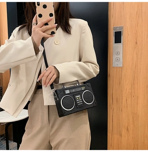 Close-up of retro radio boombox style bag with silver metal handle and PU leather texture