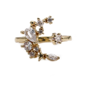 Gold moon and star open ring with micro-pave cubic zirconia on a white background