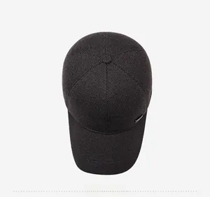 Top down macro view of thick charcoal wool baseball cap with fine texture and button top
