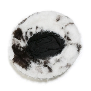 Detail view of the black and white cow print plush bucket hat with soft inner lining
