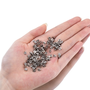 Bulk silver stainless steel earring backs held by hand to show small size
