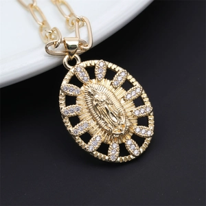 Detailed close-up of Virgin Mary oval pendant with gold paperclip chain and cubic zirconia