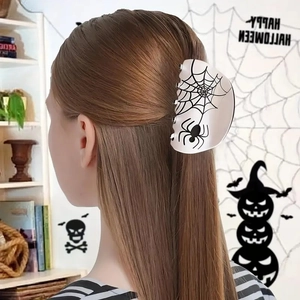 White Halloween spider web hair claw clip with black pattern worn by a model