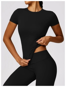 Detail of a slim fit black quick-dry yoga T-shirt showing fabric texture and waistline