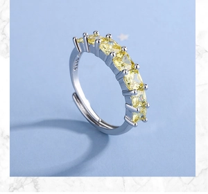 Close-up of S925 hallmark on a wide silver ring featuring square yellow zircons