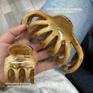Detail of large hair claw clip showing oil paint brush texture and amber wood grain