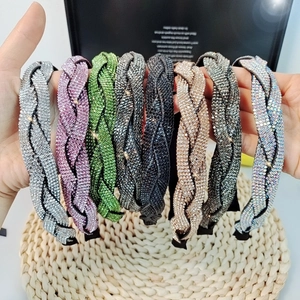 Sparkly braided rhinestone headbands for women in multiple colors shown in hand