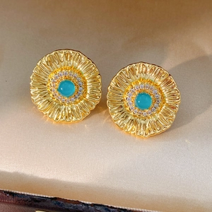 Detail of sunflower stud earring with turquoise center stone and micro-paved zircons