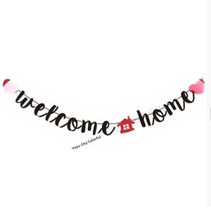 Detail of Welcome Home banner with black artistic letters and red heart sequins