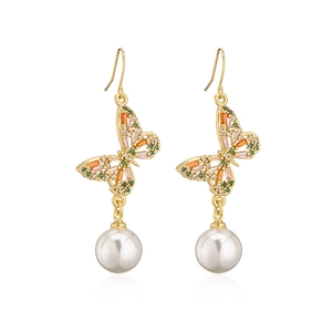 Detailed view of gold butterfly earrings with colorful zircons and white pearl drop
