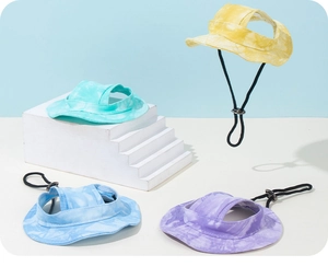 Close-up of tie-dye canvas pet hats with adjustable cords and ear holes for dogs