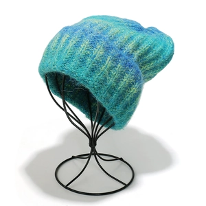 Detailed close-up of gradient tie-dye knit beanie texture in blue and yellow hues