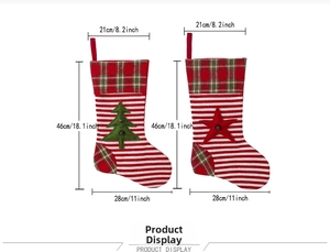 Detail of knitted Christmas stockings with tree and star patterns in red and green
