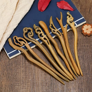 Set of 6 handcrafted sandalwood hair sticks with vintage patterns on a wooden table